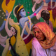 An Indian widow walks past the painting of Lord Krishna and his concert Radha during Holi, the arrival of spring festival at the Gopinath temple in Vrindavan, March 9. (AP Photo /Manish Swarup)